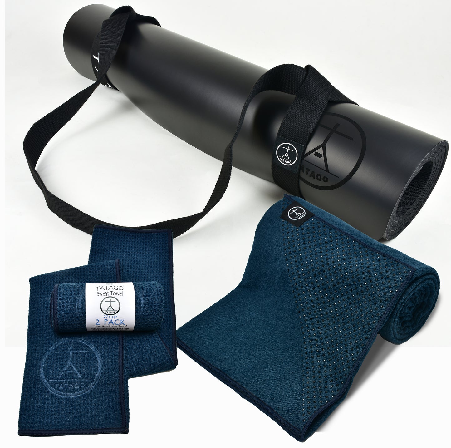 Rubber yoga mat and grippy yoga towel displayed with a yoga mat strap and sweat towels for hot yoga and Bikram sessions.