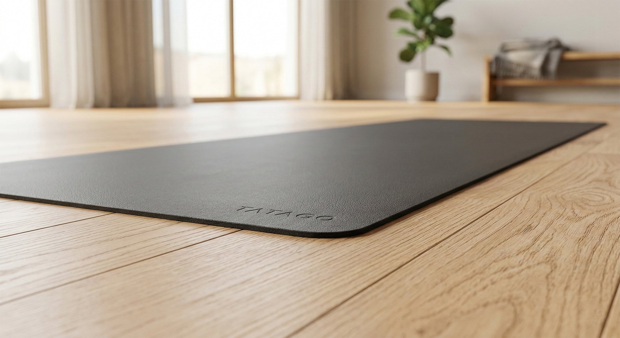 3mm thin yoga mat laid out on a wooden floor in studio