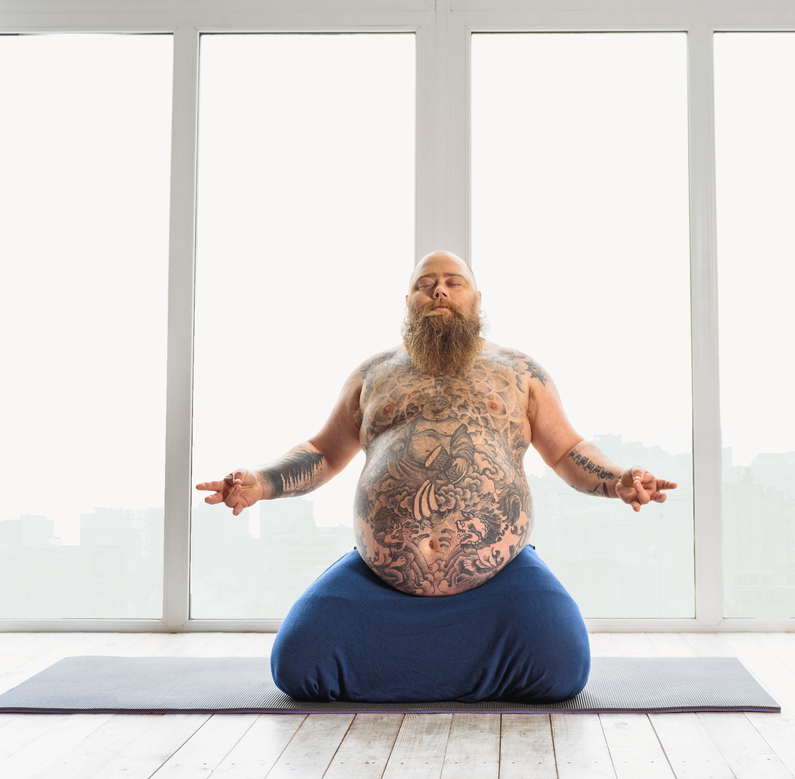 big man on a  plus size yoga mat thick and wide