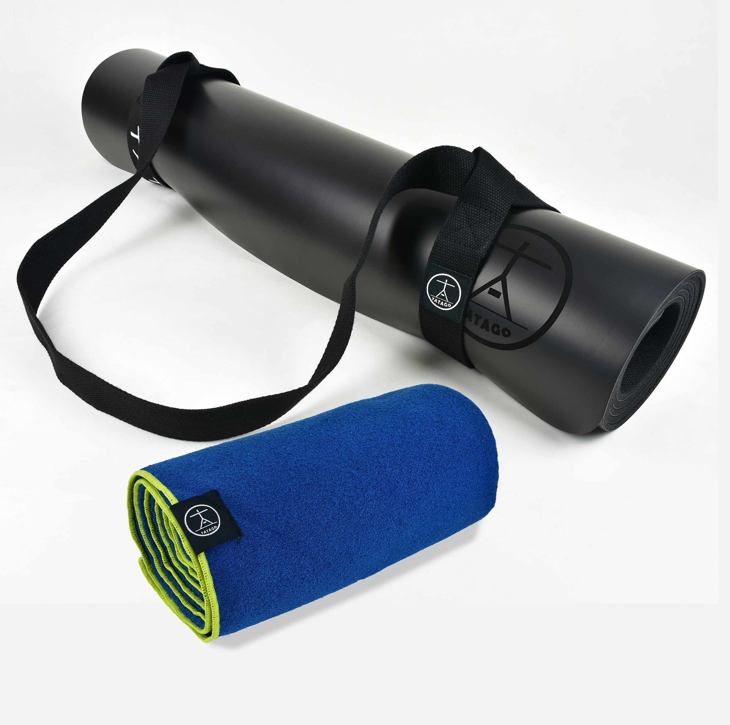 Extra-large black yoga mat with carrying strap shown with blue hot yoga towel, ideal for hot yoga, Bikram, and Pilates sessions.
