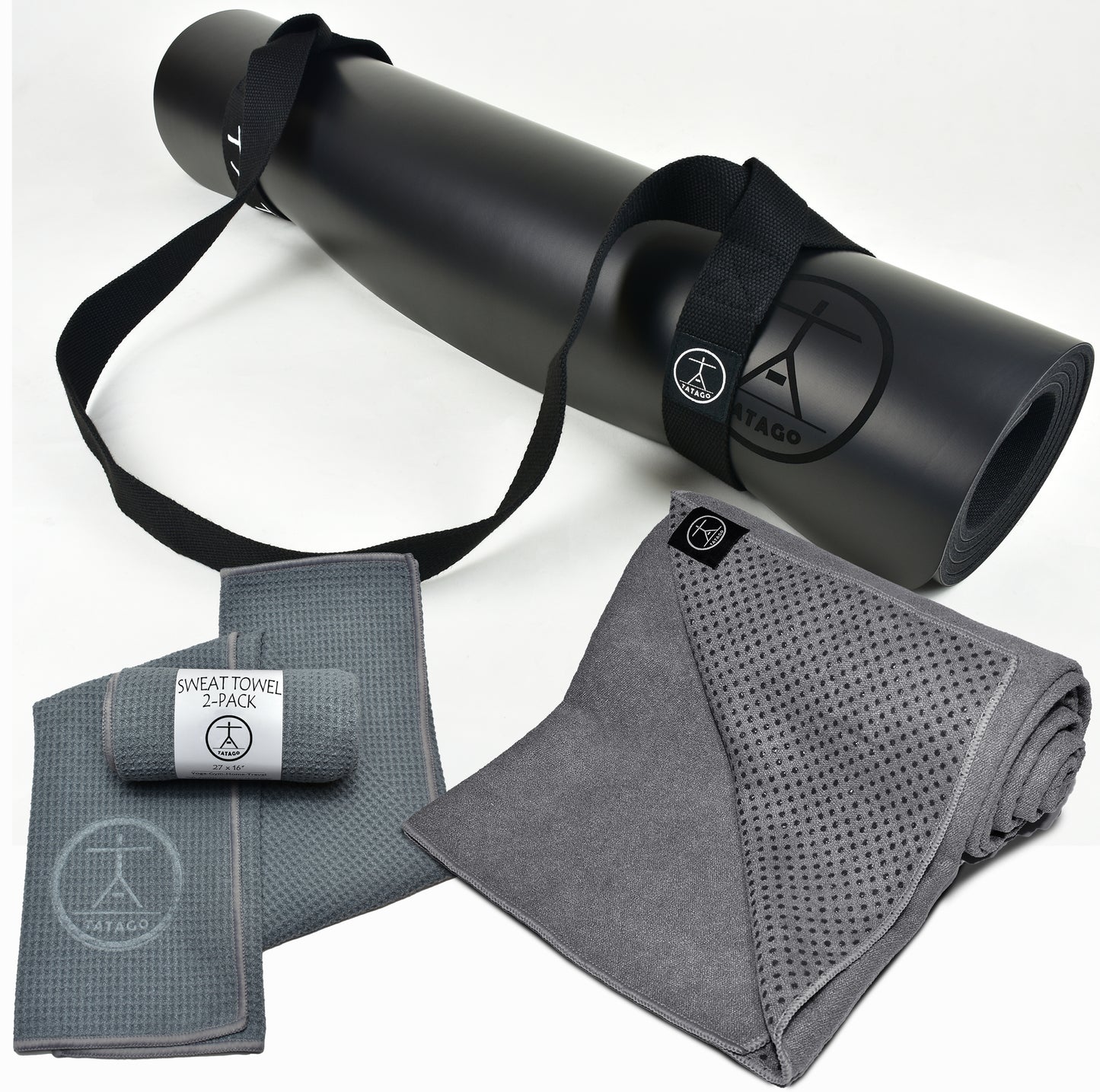 Black yoga mat with straps, gray sweat towel, and cooling towel on a white background