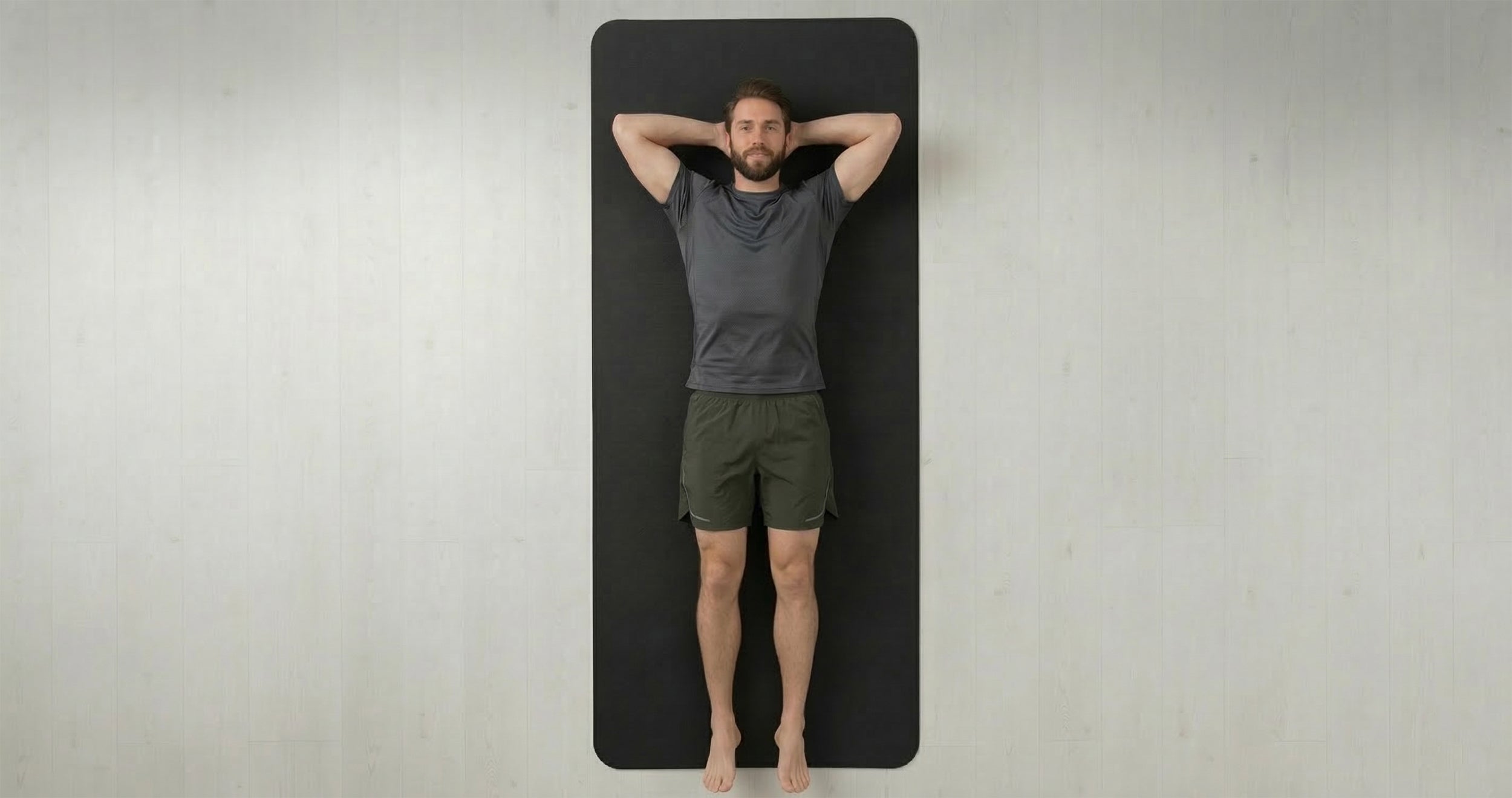 Man relaxing on an extra large yoga mat showing the spacious comfort