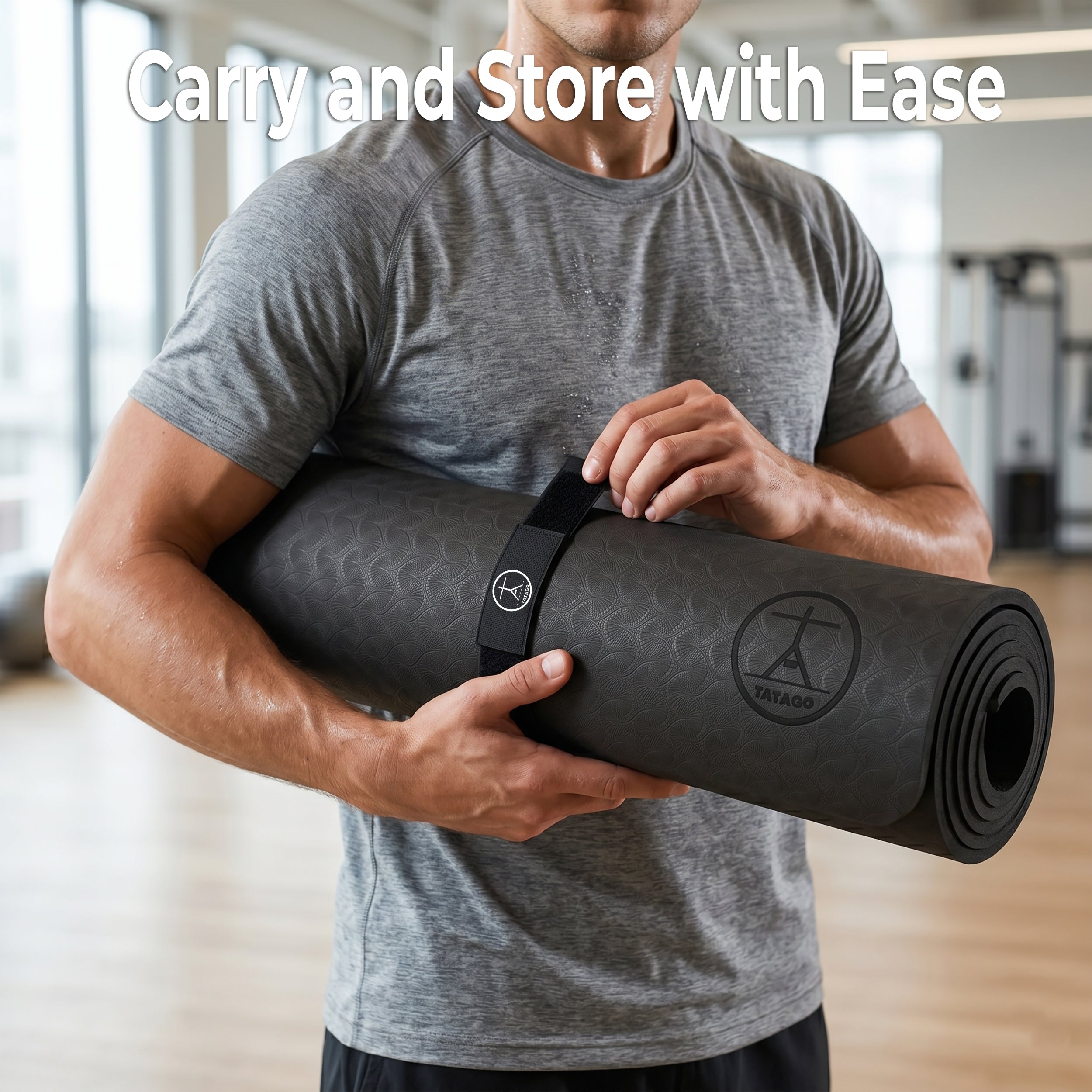 Man holding rolled extra large yoga mat with carry strap