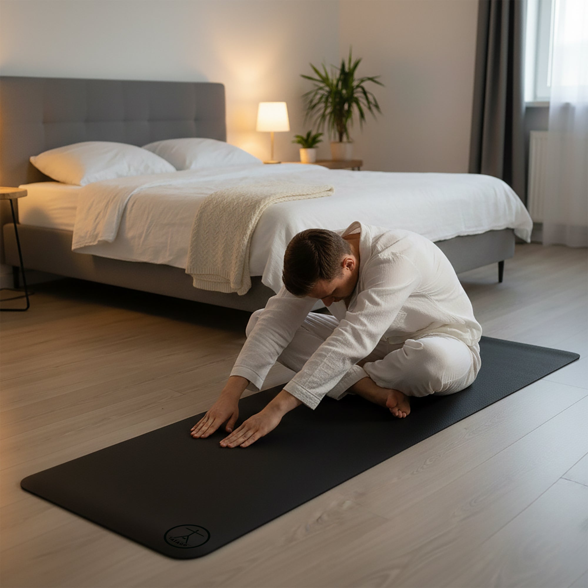 A man stretching on an xl yoga mat in his bedroom for back pain relief