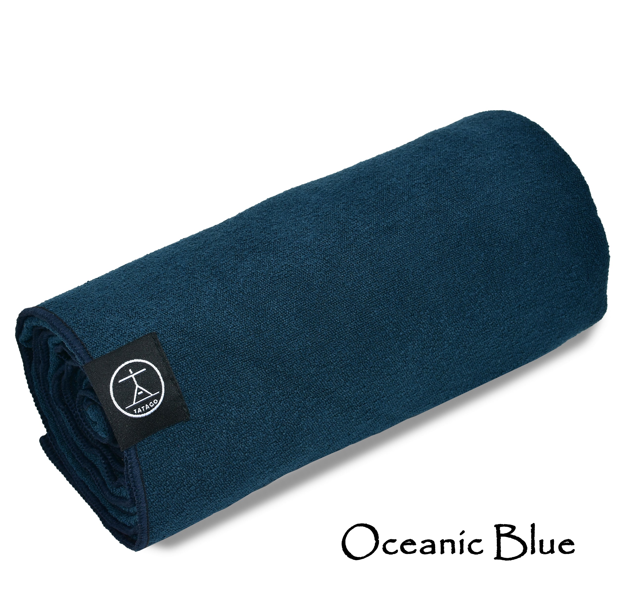 Microfiber yoga towel rolled in blue with Tatago tag (Oceanic Blue)