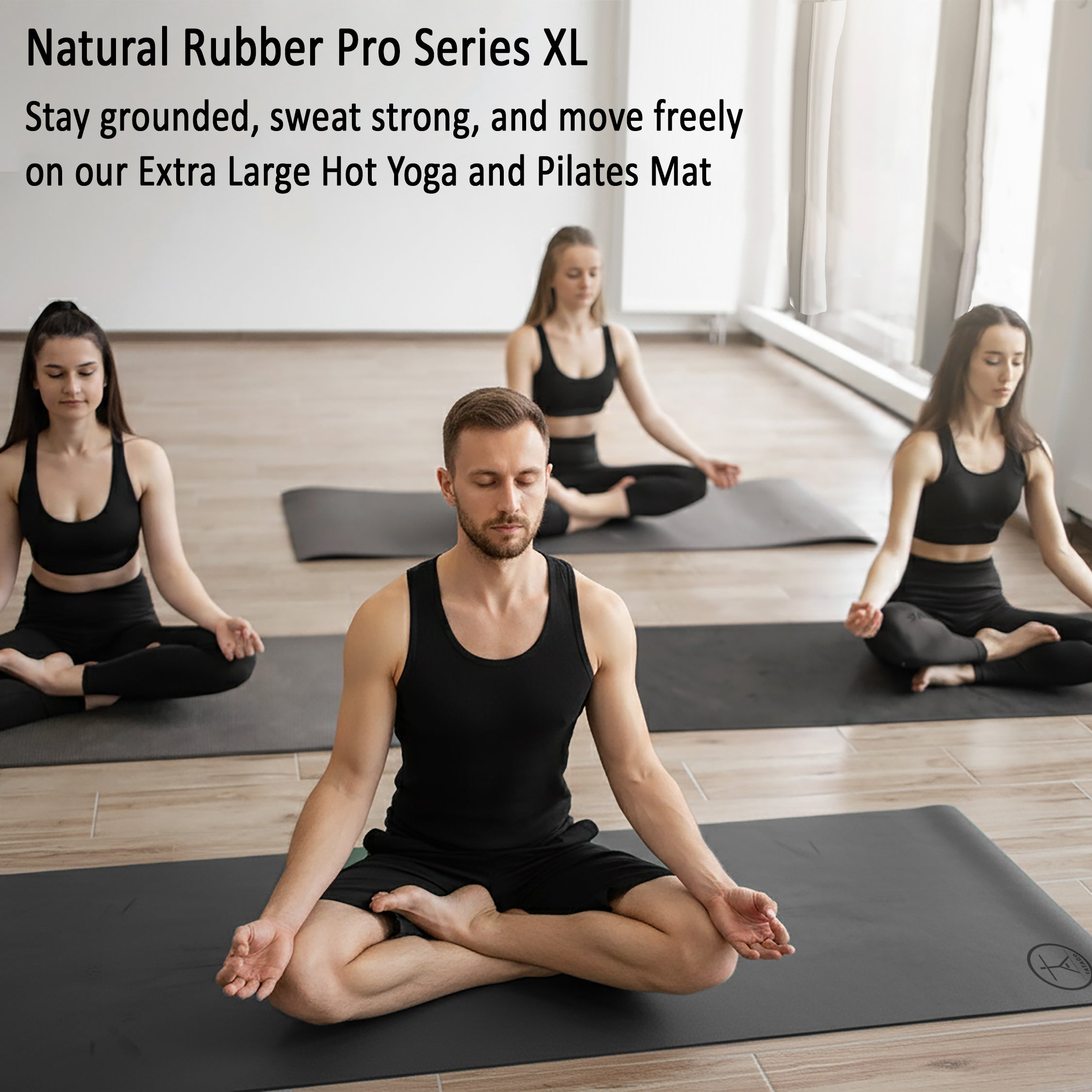 Group hot yoga class practicing on Tatago Natural Rubber Pro XL extra large non slip yoga mats with superior grip for Pilates and sweaty sessions