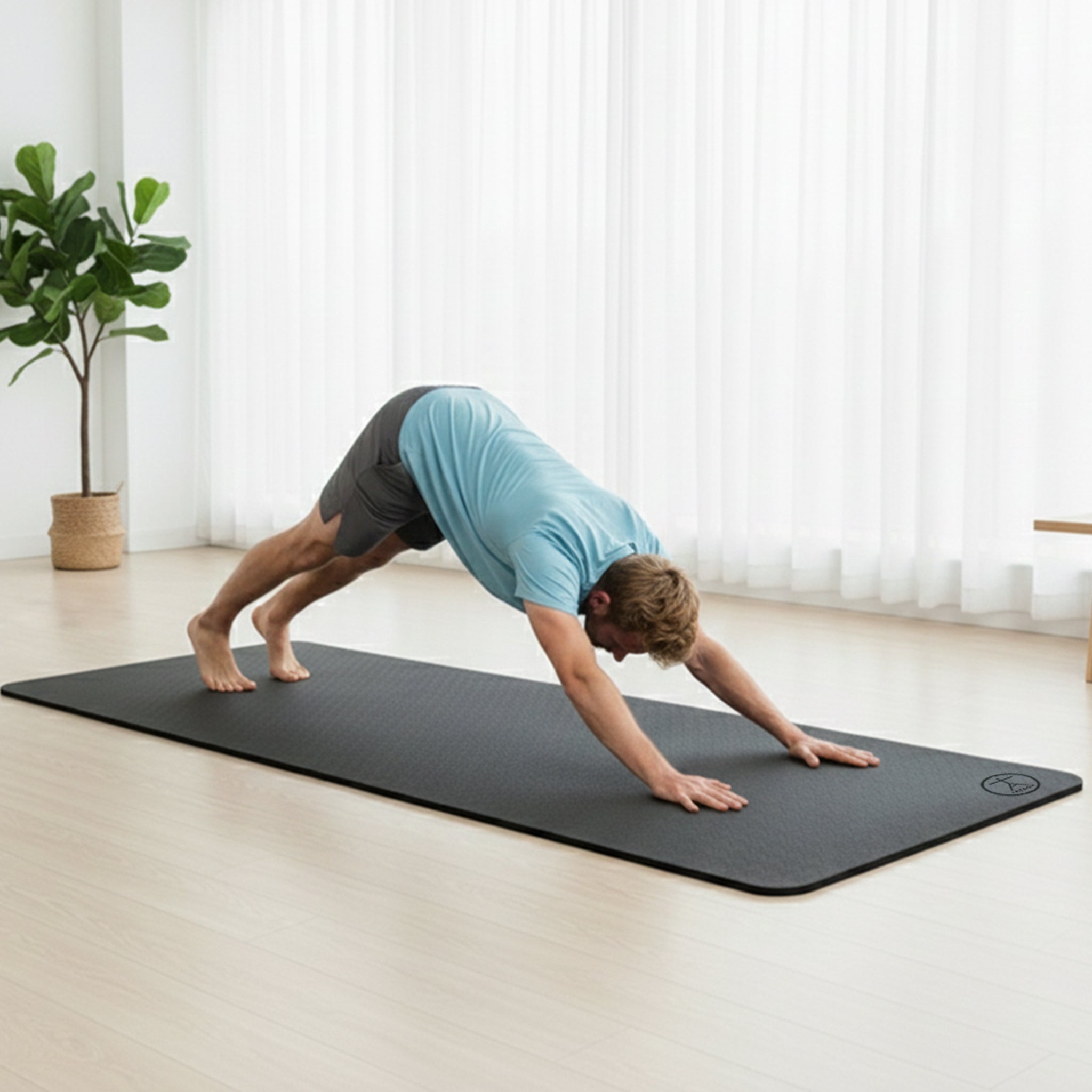 Woman practicing yoga on extra thick wide yoga mat for home workouts and pilates comfort