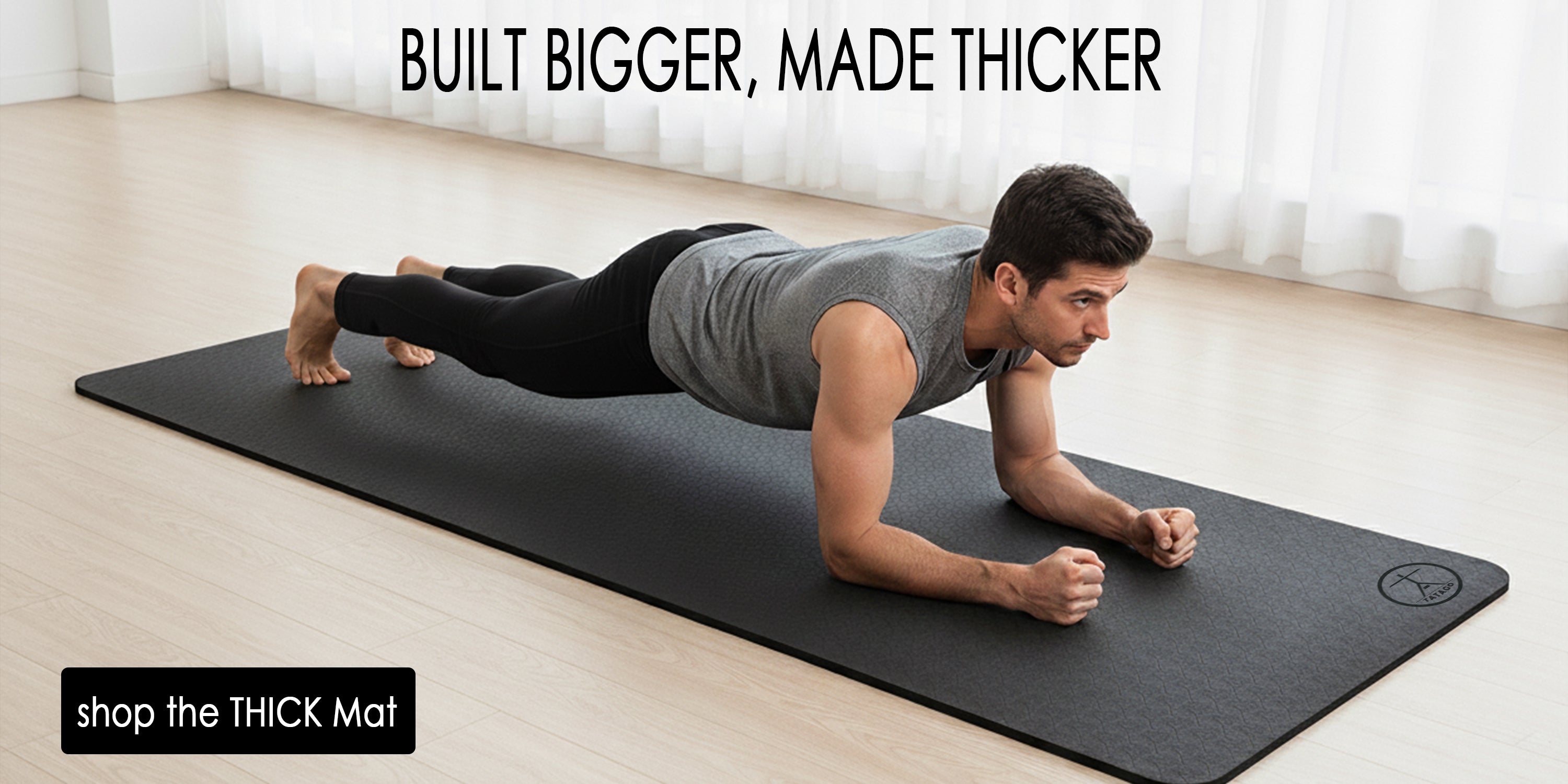 A extra large thick yoga mat with a man stretching in his home.