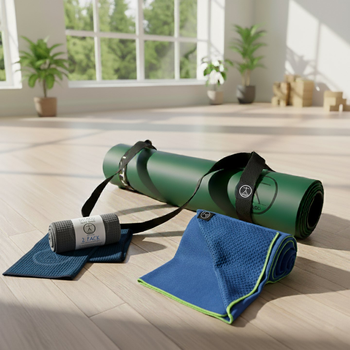 Good exercise mat bundle featuring XL natural rubber yoga mat with blue silicone-grip towel and microfiber sweat towels in a bright studio.