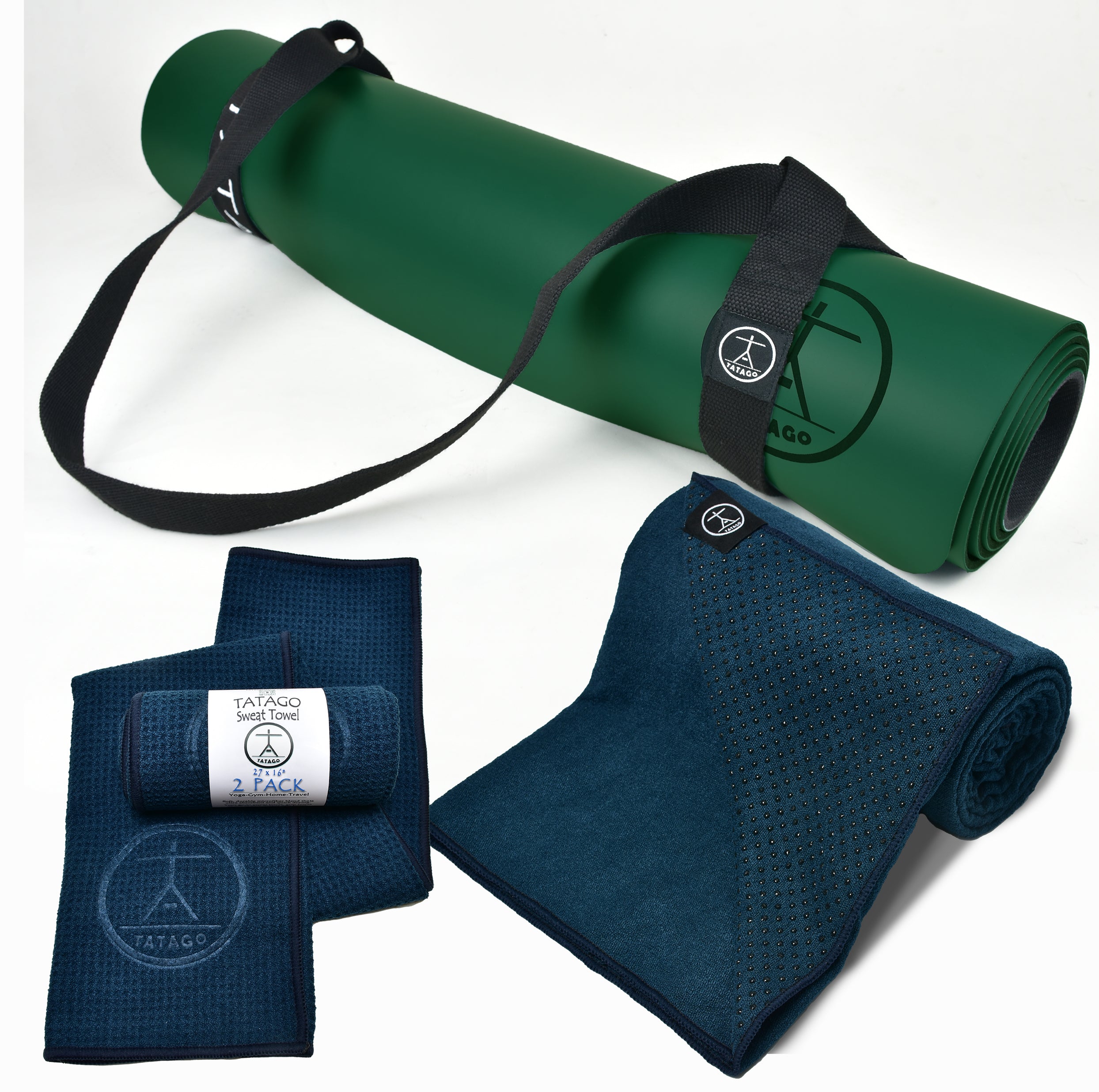 Rolled natural rubber yoga mat with yoga towel with grip and cotton yoga strap inside a bright studio, showing towel on yoga mat setup for warm yoga and hot yoga gear.